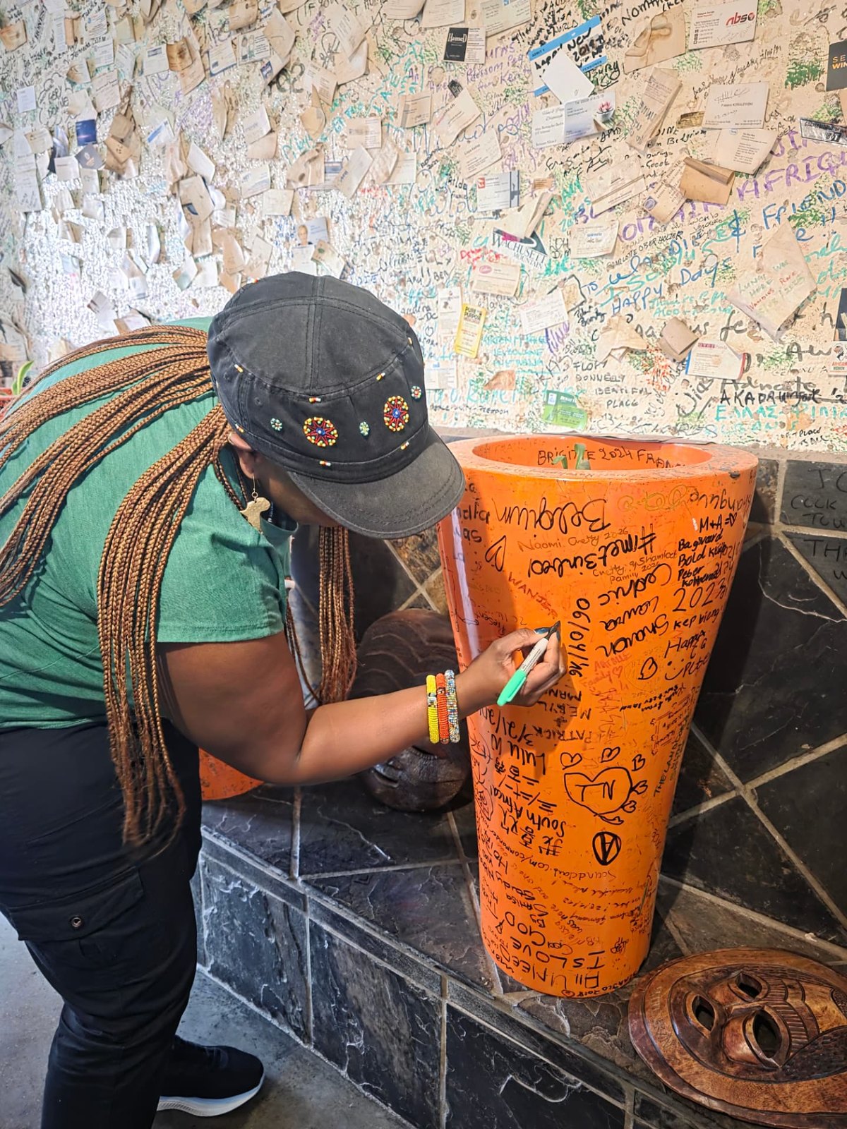 Signing the colourful wall